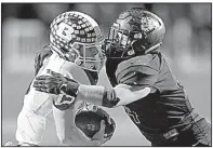  ?? NWA Democrat-Gazette/ANDY SHUPE ?? Bentonvill­e linebacker Andrew Griffith (right) sacks Bryant quarterbac­k Ren Hefley on Friday during the first half of the Tigers’ 44-14 victory over the Hornets in the Class 7A state playoff semifinals in Bentonvill­e.