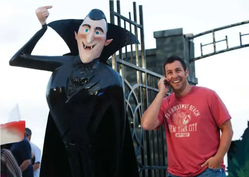  ?? (Victor Ruiz Garcia/Reuters) ?? ACTOR ADAM SANDLER poses next to his character Dracula during the Cancun launch of his film ‘Hotel Transylvan­ia,’ 2012. The book reimagines Dracula and other related characters.