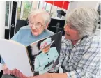  ??  ?? Royal seal of approval Jenny and her daughter Margaret Muir read a birthday card Jenny recieved from the Queen