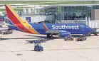  ?? MARK HOFFMAN/USA TODAY NETWORK ?? Baggage is loaded onto a Southwest Airlines plane last summer at Mitchell Airport in Milwaukee, Wis. The airline is struggling as travel has surged, catching Southwest short-handed.