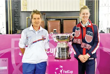  ?? — AFP photo ?? Member of Czech Fed Cup team Barbara Strycova and member of US Fed Cup team Alison Riske pose with the trophy after a draw ceremony on November 9, 2018 in Prague on the eve of the start of the tennis Fed Cup final, Czech Republic vs USA.