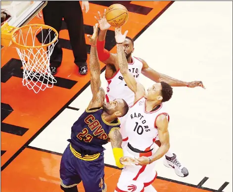  ??  ?? LeBron James #23 of the Cleveland Cavaliers goes up for the ball against Patrick Patterson #54 and DeMar DeRozan #10 of the Toronto Raptors in the fourth quarter in game four of the Eastern Conference Finals during the 2016 NBA Playoffs at the Air...