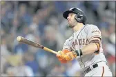  ?? RONALD MARTINEZ — GETTY IMAGES ?? The Giants’ Evan Longoria watches his solo home run against the Dodgers during the fifth inning of Game 3 of their National League Division Series at Dodger Stadium on Monday in Los Angeles.