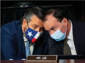  ?? (AP/The Washington Post/Bill O’Leary/Pool) ?? Sen. Ted Cruz (left), R-Texas, speaks with Sen. Mike Lee, R-Utah, during Thursday’s confirmati­on hearing for Supreme Court nominee Amy Coney Barrett. The committee scheduled an Oct. 22 vote to recommend the nomination to the full Senate.