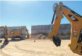  ?? EUGENE GARCIA AP ?? Crews repair a breach in the U.S.-Mexico border fence on Wednesday that authoritie­s say allowed the entry of vehicles involved in human smuggling.