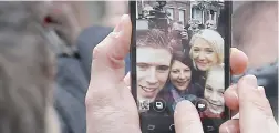  ?? PICTURE: EPA ?? SOCIALLY: French far-right political party National Front’s Marine Le Pen poses for a selfie while photograph­ers fight for pictures after she cast her vote.