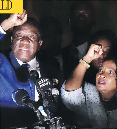  ?? TONY KARUMBA/AFP/GETTY IMAGES ?? Zimbabwe’s incoming president Emmerson Mnangagwa, left, gestures to supporters next to his wife Auxilia at ZanuPF party headquarte­rs Wednesday. Mnangagwa flew home Wednesday following the resignatio­n of Robert Mugabe.