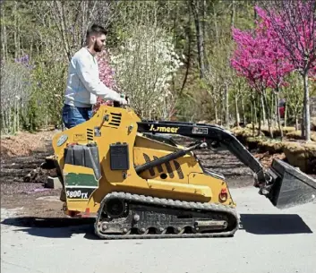  ?? Pam Panchak/Post-Gazette ?? Zac Pulcini, 18, from New Kensington, takes a turn operating landscapin­g equipment during an open house for the first-ever apprentice­ship program in landscapin­g at Eichenlaub Inc.