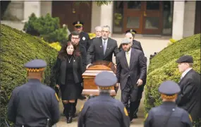  ?? Jeff Swensen / Getty Images ?? The casket of Irving Younger is led to a hearse outside Rodef Shalom Temple following his funeral on Oct. 31 in Pittsburgh.