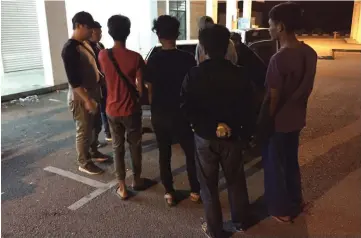  ??  ?? AADK personnel guard some of the suspects (back facing camera) arrested during ‘Ops Perdana’.