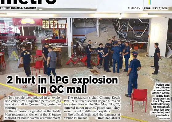  ?? BOY SANTOS ?? Police and fire officers examine the kitchen of the Teddy Man restaurant at the Z Square Mall following an explosion that left two people injured yesterday.