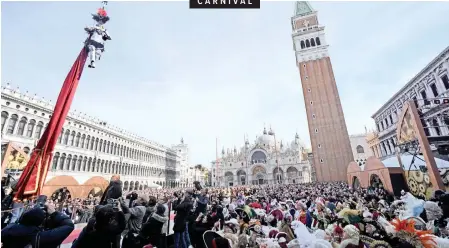  ?? | EPA ?? THE ‘Angel Warrior’ of the 2019 Venice Carnival descends on a zip line from the Campanile (Bell Tower) into Piazza San Marco (St Mark’s Square) during the official opening of the carnival yesterday.