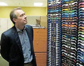  ?? [AP PHOTO] ?? American Paper Optics President and CEO John Jerit looks at a display of solar eclipse glasses in Bartlett, Tenn. Jerit said the company began preparing about two years ago for the August 2017 event.