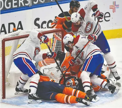  ?? ED KAISER ?? Canadiens players crowd the Oilers net as goaltender Mikko Koskinen searches for the puck at Rogers Place in Edmonton on Monday. In their two games in Edmonton, Montreal's penalty killers scored two short-handed goals and held the Oilers to 0-for-10 on the power play.