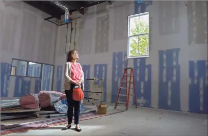  ?? H John Voorhees III / Hearst Connecticu­t Media ?? Lorna Rhyins, library director, stands in the new children’s space of the New Milford Library on Sept. 3. The expansion and renovation constructi­on work continues on the library.