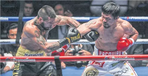  ?? EPA ?? Manny Pacquiao, right, punches Lucas Matthysse during their WBA welterweig­ht title fight in Kuala Lumpur.