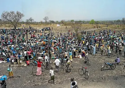  ?? PHOTO: GETTY IMAGES ?? Refugees queue at a World Food Programme (WFP) food distributi­on site at a refugee settlement in February in Palorinya, Uganda.