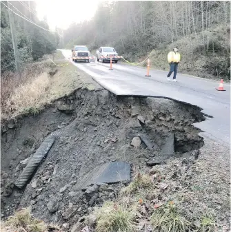  ??  ?? Stewart Road on Salt Spring Island is closed for repairs after heavy rains undermined its base.