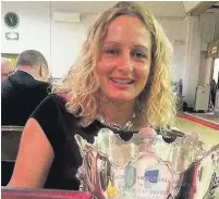  ??  ?? ●● Rebecca Battersby
with the trophy