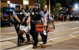  ?? JEFF ROBERSON / ASSOCIATED PRESS ?? Police arrest a man as they try to clear a violent crowd on Saturday in University City, Mo. Earlier, protesters marched peacefully in response to a not guilty verdict in the trial of former St. Louis police officer Jason Stockley.