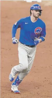  ?? RON SCHWANE/GETTY IMAGES (ABOVE), DAVID BANKS/AP ?? Ian Happ (right) runs the bases after hitting a leadoff home run against the Cardinals in Game 1. Manager David Ross said he will assess whether to keep Happ in the leadoff spot when Kris Bryant (above) returns from injury.