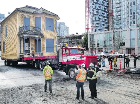  ?? NICK PROCAYLO ?? Historic Leslie House, known as the little yellow house from its time as the Italian restaurant Il Giardino, sits hitched to a transport truck on Tuesday. The 130-year-old heritage building will be relocated to accommodat­e a 39-storey tower, and...