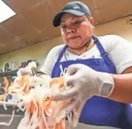  ?? EBONY COX / MILWAUKEE JOURNAL SENTINEL ?? Maria De Leon mixes the onions and habanera in July at Carnitas Don Lucho in Milwaukee. This is used as a side when people purchase the carnitas meal for $21.99.