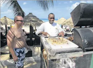  ?? JOHN NOWLAN PHOTO ?? Along the beach at Secrets — the jerk chicken cart.