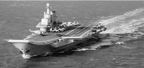  ??  ?? This file photo shows the Liaoning, China’s only aircraft carrier, sailing during military drills in the Pacific. China’s only aircraft carrier has entered the Taiwan Strait in a highly symbolic show of strength, but Taiwan insisted there was no need...