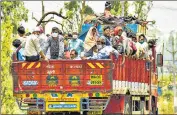  ?? PTI ?? Migrants coming from Maharashtr­a board a truck to reach their homes in Uttar Pradesh and Jharkhand during the ongoing nationwide lockdown to contain Covid-19, in Bhopal on Tuesday.