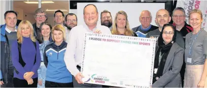  ??  ?? ●●David Bottomley, director at Rochdale AFC and Councillor Sameena Zaheer, assistant to the cabinet member for health and wellbeing, with sports club representa­tives pledging their support for smoke-free sports