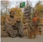  ?? — Reuters ?? A man and his monkey wait to put on a show for customers at a park in Islamabad on Wednesday.