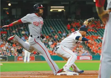  ?? Associated Press ?? n Washington Nationals' Alejandro De Aza is out at first behind the throw to Houston Astros' first baseman Yuli Gurriel during the third inning of a baseball game Thursday in Houston.