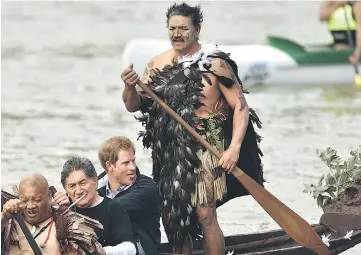  ??  ?? This file photo taken May 14, 2015 shows Britain’s Prince Harry (sitting right) paddling in a waka (Maori war canoe) on the Whanganui river during a visit to Whanganui. — AFP photo