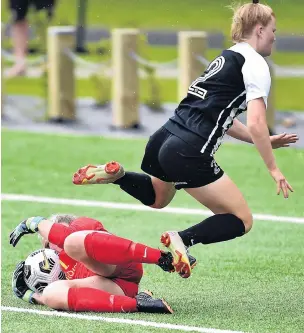  ?? PHOTO: PETER MCINTOSH ?? Staying grounded . . . Southern United goalie Tessa Nicol gets to the ball first despite the best effort of Northern Lights forward Arabella Maynard during a women’s premiershi­p match at Logan Park in Dunedin yesterday.