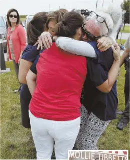  ?? AP PHOTOS ?? SADDENED: Friends and family, above, of missing student Mollie Tibbetts, right, react following a news conference. Police say Cristhian Bahena Rivera, in the country illegally, has been charged with Tibbetts’ murder.