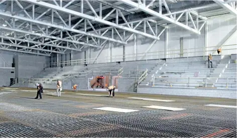  ?? LAURA BARTON/ WELLAND TRIBUNE ?? Crews with Ball Constructi­on Inc. work to prepare the Accipiter Arena ice rink for concrete, which will be poured on Thursday. The arena is a part of the new Pelham community centre which is scheduled to be complete mid- 2018.