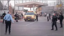  ?? ARIEL SCHALIT/ ASSOCIATED PRESS ?? An ambulance leaves Sharon Prison on Sunday as an Israeli police SWAT team responds to a standoff with an American prisoner who reportedly took a gun from a guard and opened fire. The inmate, Samuel Sheinbein, was killed.