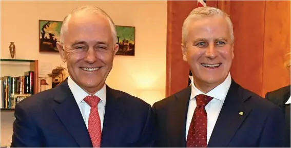  ?? PHOTO: MICK TSIKAS/AAP ?? ALL SMILES: Prime Minister Malcolm Turnbull and Deputy Prime Minister Michael McCormack share the joy at Parliament House yesterday.