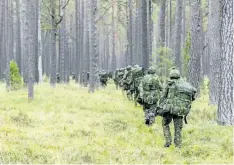  ?? CANADIAN FORCES HANDOUT ?? Canadian troops move through a forest in Kadaga, Latvia, as part of a training exercise on Sept. 25, 2015.