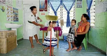  ??  ?? A Kiribati family at their local medical clinic.