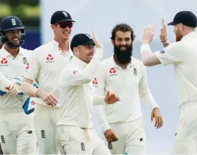  ?? (Reuters) ?? England’s Moeen Ali (second from right) celebrates with his teammates Ben Stokes (right), Jack Leach (centre), Keaton Jennings (second from left) and Ben Foakes after taking the wicket of Sri Lanka’s Niroshan Dickwella (not pictured) on Day Four of the first Test in Galle, Sri Lanka, yesterday.