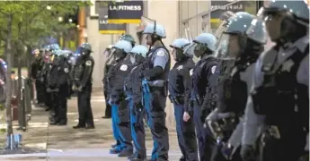  ?? SUN-TIMES FILES ?? A Chicago officer has had his police powers stripped after flipping off protesters Thursday.