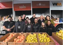  ?? Noah Graham / Golden State Warriors 2018 ?? Stephen Curry (back row, center) and wife, Ayesha (back row, far right), during the Currys’ Christmas event in Oakland. The Currys have launched their new Eat, Learn, Play foundation.