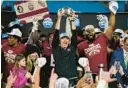  ?? ERIK VERDUZCO/AP ?? Florida State coach Mike Norvell lifts the trophy after the team’s win over Louisville in the Atlantic Coast Conference championsh­ip game on Saturday night.