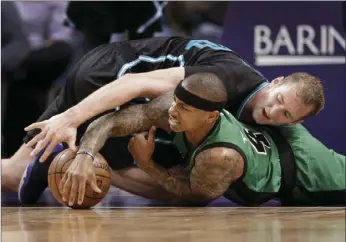  ?? AP PHOTO ?? Charlotte Hornets' Cody Zeller (top) and Boston Celtics' Isaiah Thomas vie for a loose ball in the second half of an NBA basketball game Saturday in Charlotte, N.C.