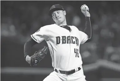  ?? ROB SCHUMACHER/THE REPUBLIC ?? Diamondbac­ks starter Patrick Corbin pitches to the San Francisco Giants in the first inning on Friday night at Chase Field.