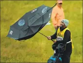  ?? ANDY BUCHANAN — AFP — GETTY IMAGES ?? Michael Greller, caddie for Jordan Spieth, battles the elements on a cold, wet and windy day at Royal Birkdale.