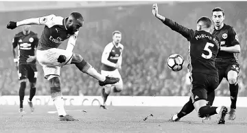  ??  ?? Arsenal’s Alexandre Lacazette (left) shoots but fails to score during the English Premier League match against Manchester United at the Emirates Stadium in London in this Dec 2 file photo. — AFP photo