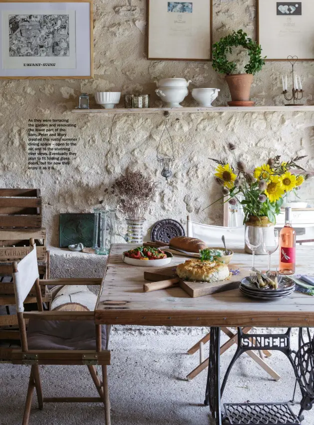  ??  ?? As they were terracing the garden and renovating the lower part of the barn, Peter and Mary created this rustic summer dining space – open to the air, and to the stunning river views. Eventually they plan to fit folding glass doors, but for now they enjoy it as it is